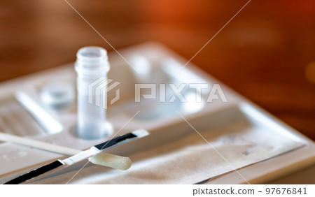 selective focus on swab of an at home rapid Covid test kit 97676841