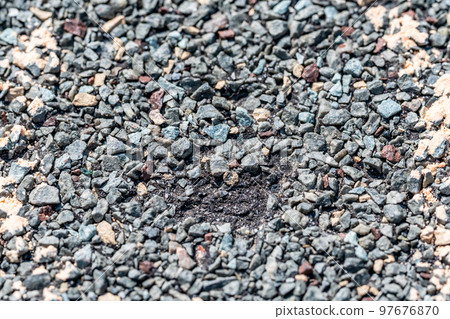Macro of hail damage on a shingle residential roof circled with a chalk outline during a home inspection. 97676870