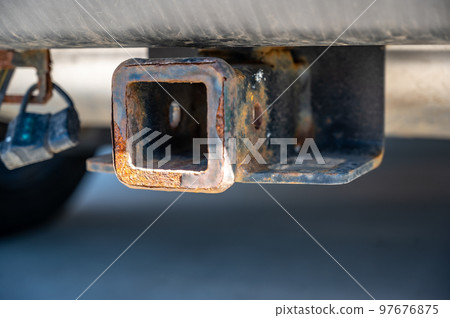 uncovered rusty trailer hitch receiver on the back of a vehicle uncovered rusty trailer hitch receiver on the back of a vehicle 97676875