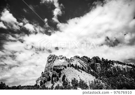 Mount Rushmore in the Black Hills of South Dakota against a cloudy sky. Mount Rushmore in the Black Hills of South Dakota against a cloudy sky. 97676910