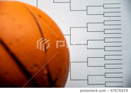 Blank bracket grid on white paper with basketball on top Blank bracket grid on white paper with basketball on top 97676979