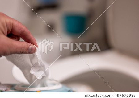 Disposable wipes being flushed down a toilet where they can cause clogging and problems with wastewater treatment. Disposable wipes being flushed down a toilet where they can cause clogging and problems with wastewater treatment. 97676985