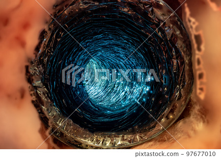 Front view looking inside a flexible pipe with thermal fiberglass insulation wrapping Front view looking inside a flexible pipe with thermal fiberglass insulation wrapping 97677010