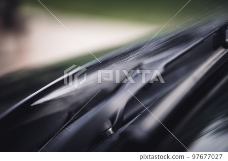 Under hood windshield washer jet used to spray liquid to clean glass on a vehicle.  97677027