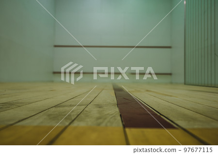 selective focus on a section of wood planking at floor level inside a racquet ball court selective focus on a section of wood planking at floor level inside a racquet ball court 97677115