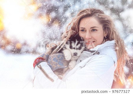 Girl playing with siberian husky in winter forest and park, animals and ecology 97677327