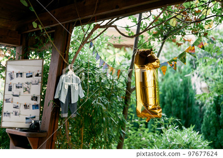 Flags and an inflatable digit 1 hang in the gazebo. High quality photo 97677624