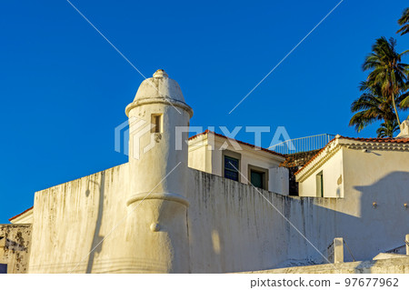 Walls and guardhouse of an old colonial fortification 97677962