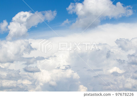 White cumulus clouds in the blue sky, illuminated by the bright spring sun. White cumulus clouds in the blue sky, illuminated by the bright spring sun. 97678226
