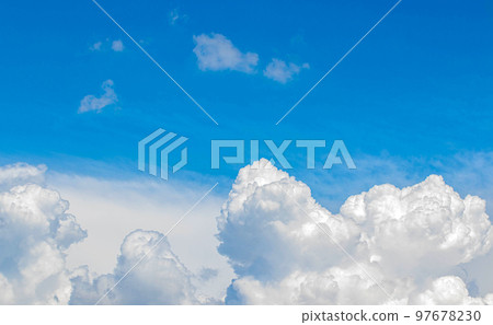 White cumulus clouds in the blue sky, illuminated by the bright spring sun. White cumulus clouds in the blue sky, illuminated by the bright spring sun. 97678230