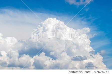 White cumulus clouds in the blue sky, illuminated by the bright spring sun. White cumulus clouds in the blue sky, illuminated by the bright spring sun. 97678232