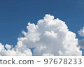 White cumulus clouds in the blue sky, illuminated by the bright spring sun. 97678233
