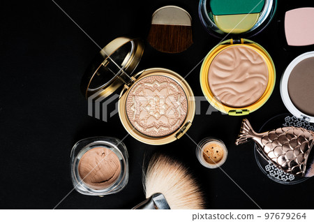 Set of bronze powder with makeup brushes on black background 97679264