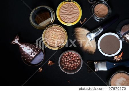 Set of bronze powder with makeup brushes on black background Set of bronze powder with makeup brushes on black background 97679270