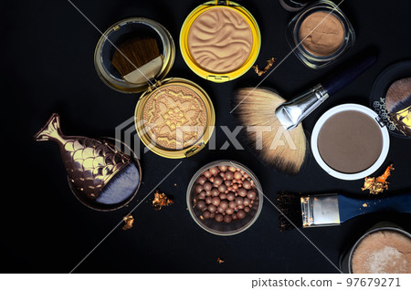Set of bronze powder with makeup brushes on black background 97679271
