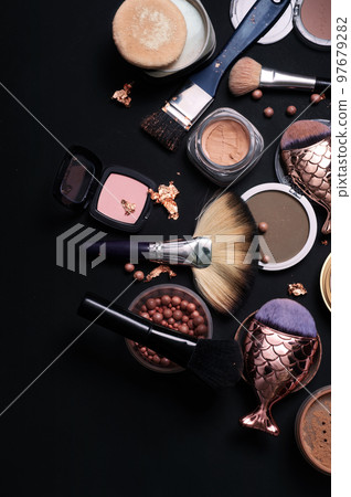 luxery Set of bronze powder with makeup brushes on black background luxery Set of bronze powder with makeup brushes on black background 97679282