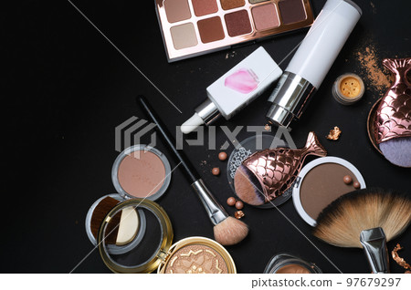 Set of bronze powder with makeup brushes on black background Set of bronze powder with makeup brushes on black background 97679297