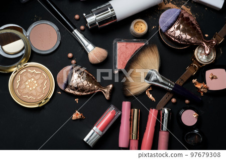 Set of bronze powder with makeup brushes on black background 97679308