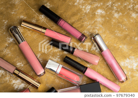 lip gloss in assortiment around golden backround 97679340