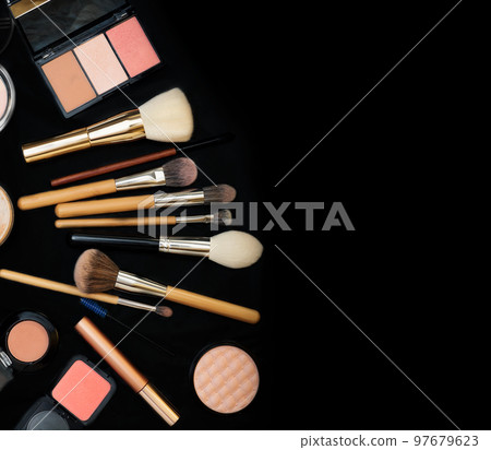 Set of make up brushes with cosmetics on black background Set of make up brushes with cosmetics on black background 97679623