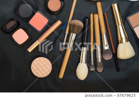 Set of make up brushes with cosmetics on black background Set of make up brushes with cosmetics on black background 97679625