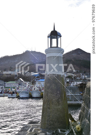 Shoot the scenery of the retro lighthouse at Irifune fishing port in Hakodate, Hokkaido in winter 97679689