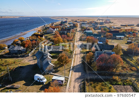 Top view of the village with houses, green fields on the background. 97680547