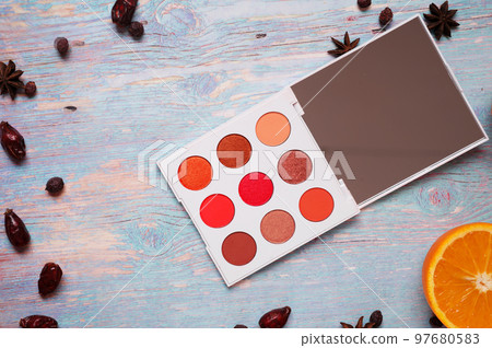 fashion summer eye palettes with fruit and herbs at blue wooden background. close up fashion summer eye palettes with fruit and herbs at blue wooden background. close up 97680583