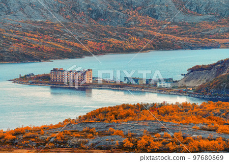 Autumn lake in colorful forest. Town in Liinahamari. 97680869
