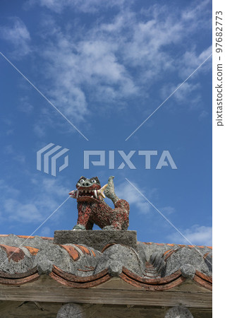 Shisa enshrined on a red Ryukyu tile and plastered roof, Taketomi Island, Important Preservation District for Groups of Traditional Buildings 97682773