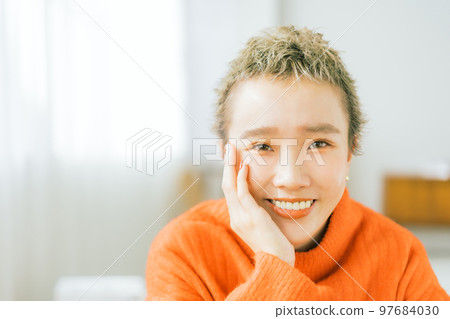Belly short woman wearing orange knit Belly short woman wearing orange knit 97684030