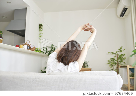 Back view of a man stretching at home Back view of a man stretching at home 97684469