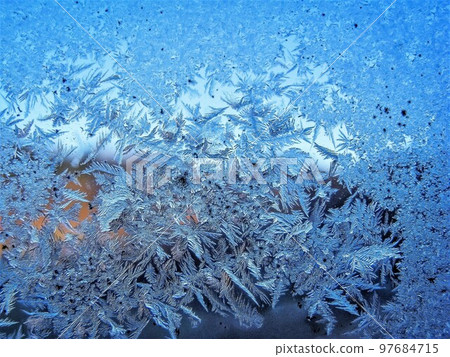 Frost crystals on glass Mysterious pattern art Frost crystals on glass Mysterious pattern art 97684715