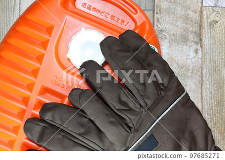hot water bottle and gloves 97685271