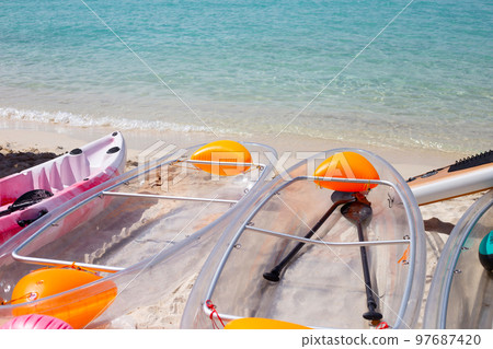 Transparent kayak canoe on the beach 97687420