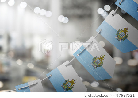 A garland of San Marino national flags on an abstract blurred background A garland of San Marino national flags on an abstract blurred background 97687521