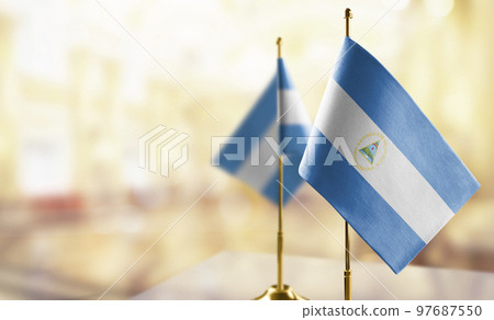 Small flags of the Nicaragua on an abstract blurry background Small flags of the Nicaragua on an abstract blurry background 97687550