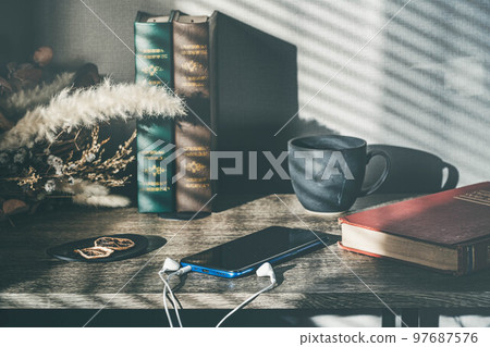 Light by the window, a cup and a smartphone Light by the window, a cup and a smartphone 97687576