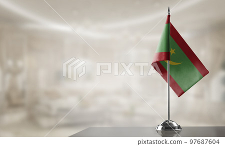 A small Mauritania flag on an abstract blurry background 97687604