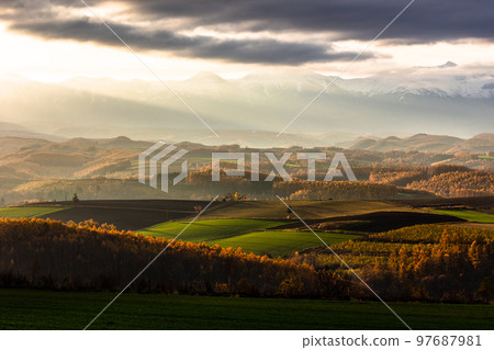 Biei, Hokkaido, morning light coming through the clouds, Japan 97687981