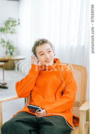 A woman listening to music 97688096