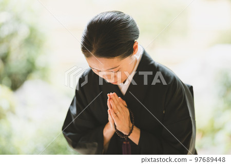 pressing one's hands together in prayer, please or with respect in buddhist correspondence, female 97689448