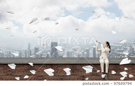 Elegant young woman playing trumpet 97689794