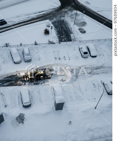 Tractor clears the way after heavy snowfall. Tractor clears the way after heavy snowfall. 97689934