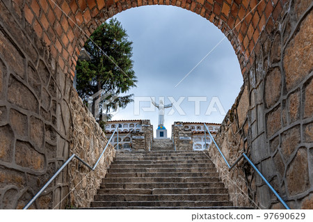 Statue of Christ in a cemetery in the city of Yungay under Mount Huascaran in Peru 97690629