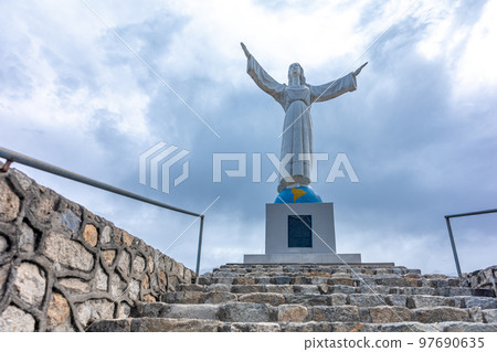 Statue of Christ in a cemetery in the city of Yungay under Mount Huascaran in Peru 97690635