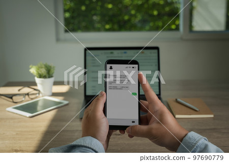 Man sending text message and sms with smartphone Communication Text Message Using Mobile Phone Online chat chatting 97690779