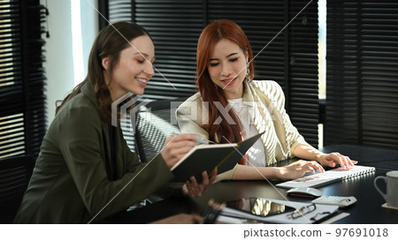 Smiling business coworkers planning marketing strategy, discussing over new business project at modern office Smiling business coworkers planning marketing strategy, discussing over new business project at modern office 97691018