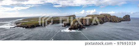 The cliffs and sea stacks An Tor Mor and the Wishing Stone at Port Challa on Tory Island, County Donegal, Ireland The cliffs and sea stacks An Tor Mor and the Wishing Stone at Port Challa on Tory Island, County Donegal, Ireland 97691019