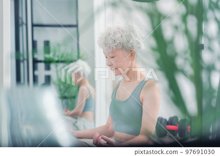 A healthy senior woman doing yoga 97691030